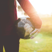 a person holding the globe in their hands